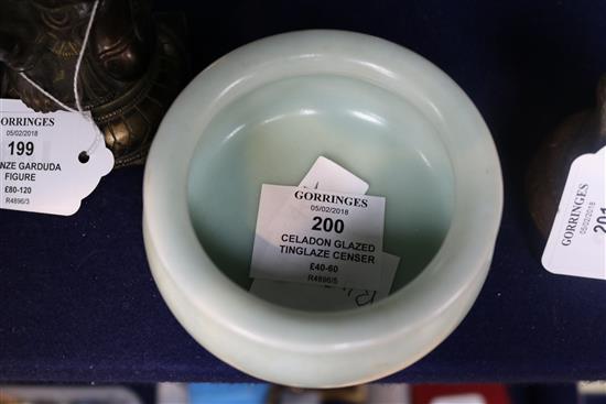 A Chinese Celadon glazed tripod censer